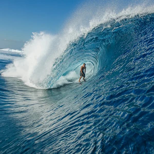 Long-period ground swell wrapping around a point and peeling toward shore