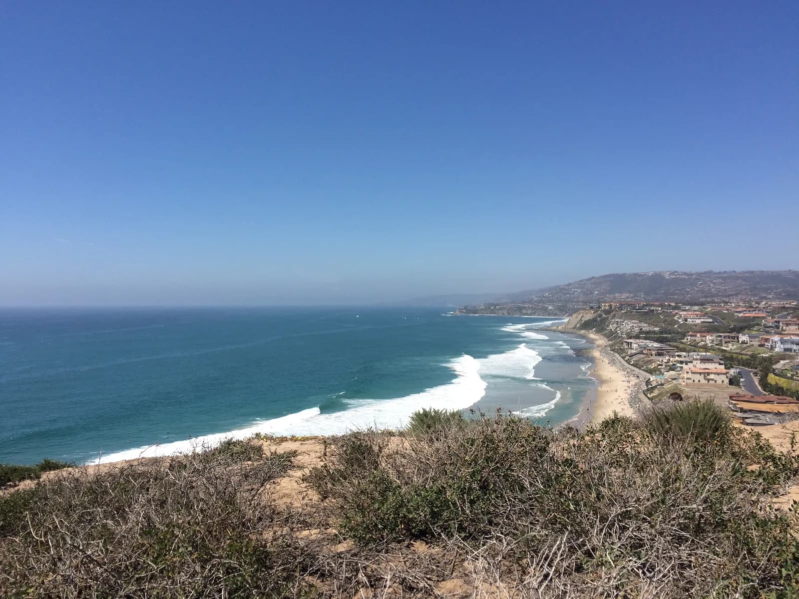 Strands Beach and the coast beyond, seen from the Dana Point Headlands, with white lines of surf