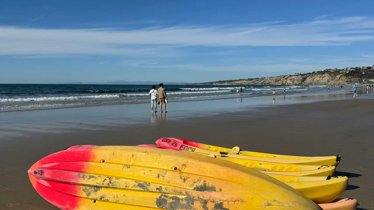 La Jolla Shores beach with boards and soft surf